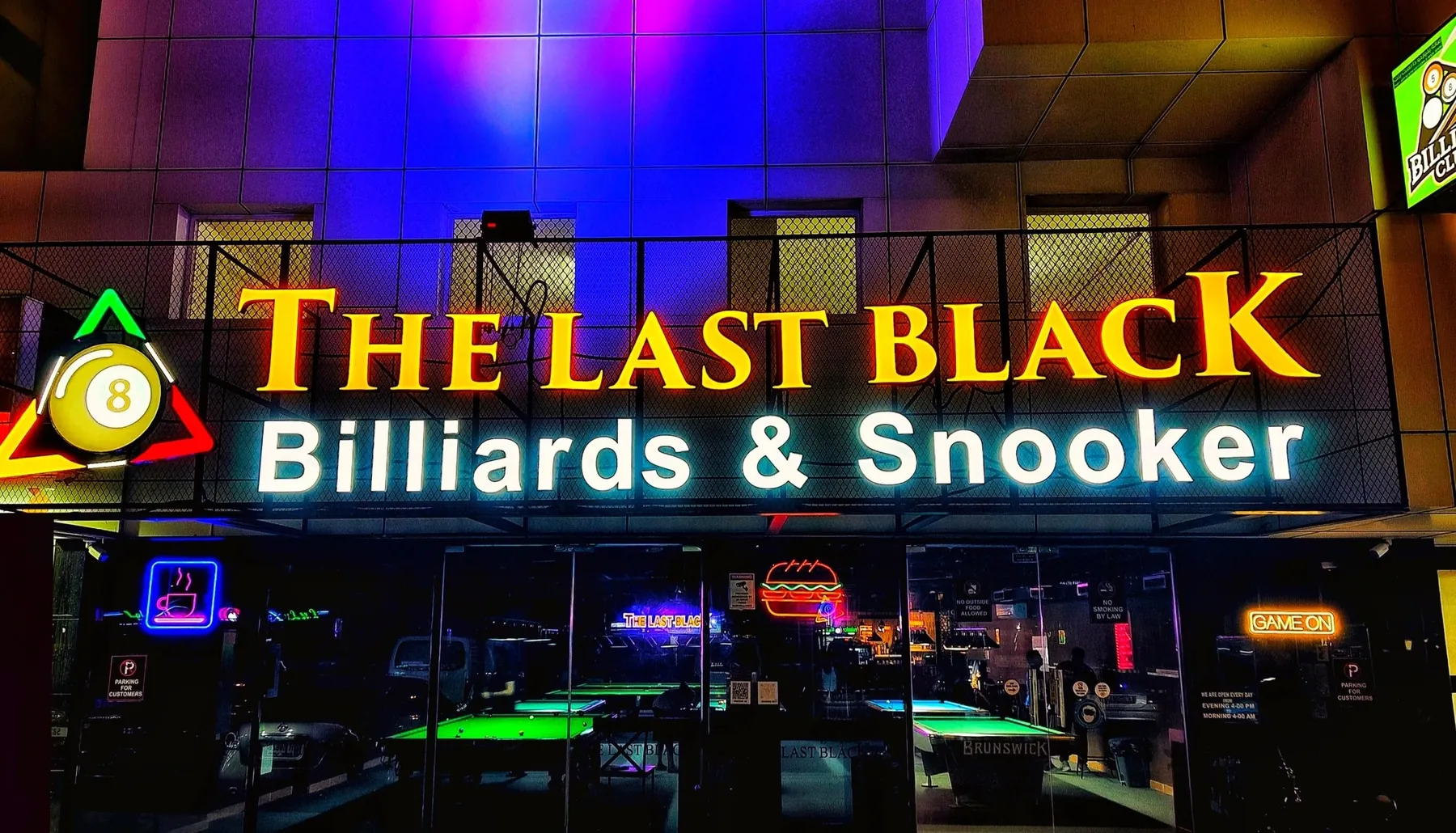 The Last Black signage at night