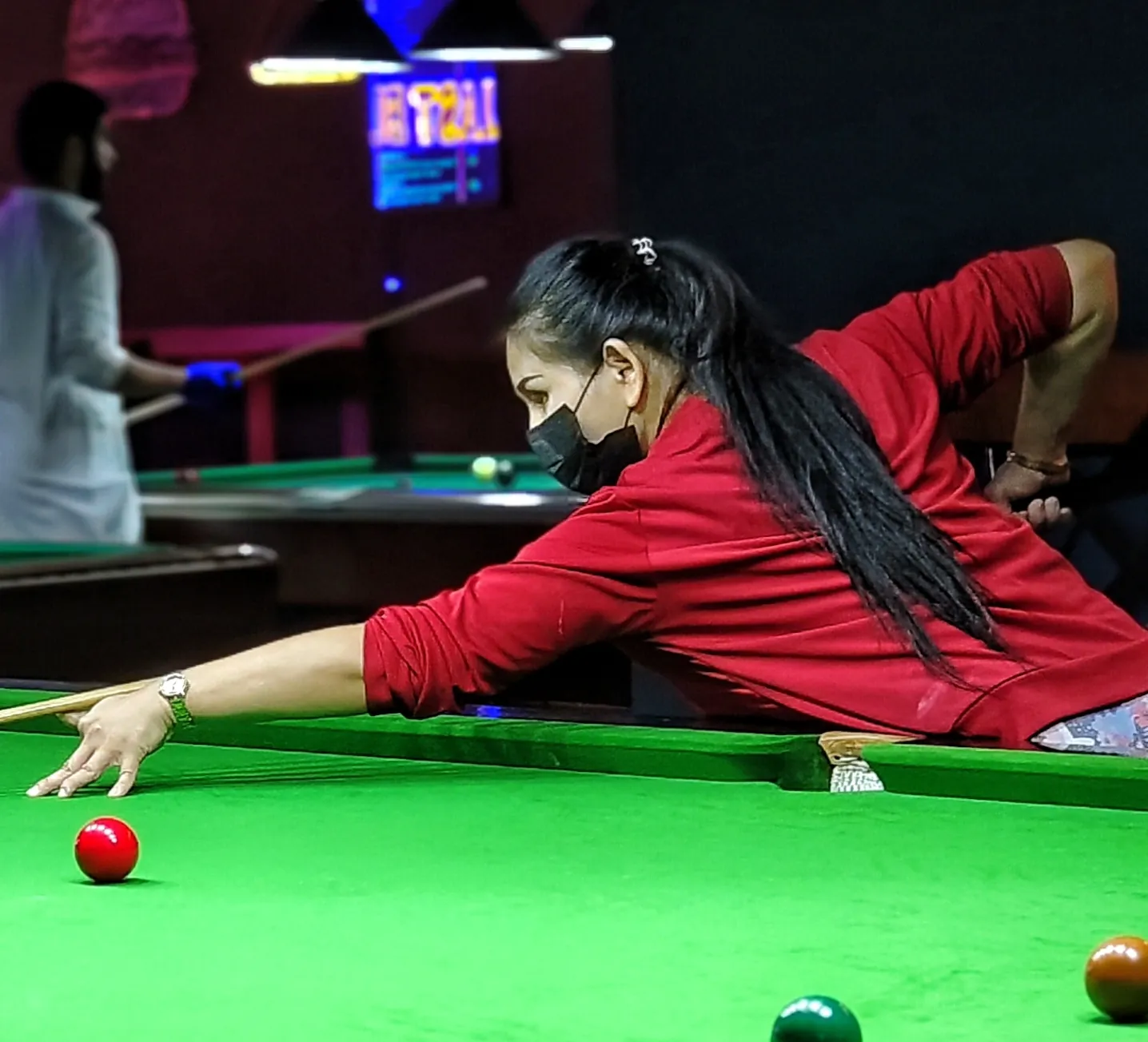 Player taking a shot in a red jacket